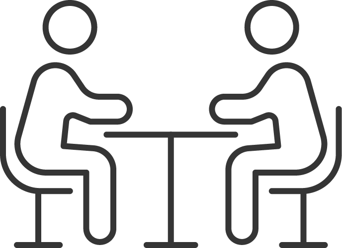 Icon of two people sitting at a table.